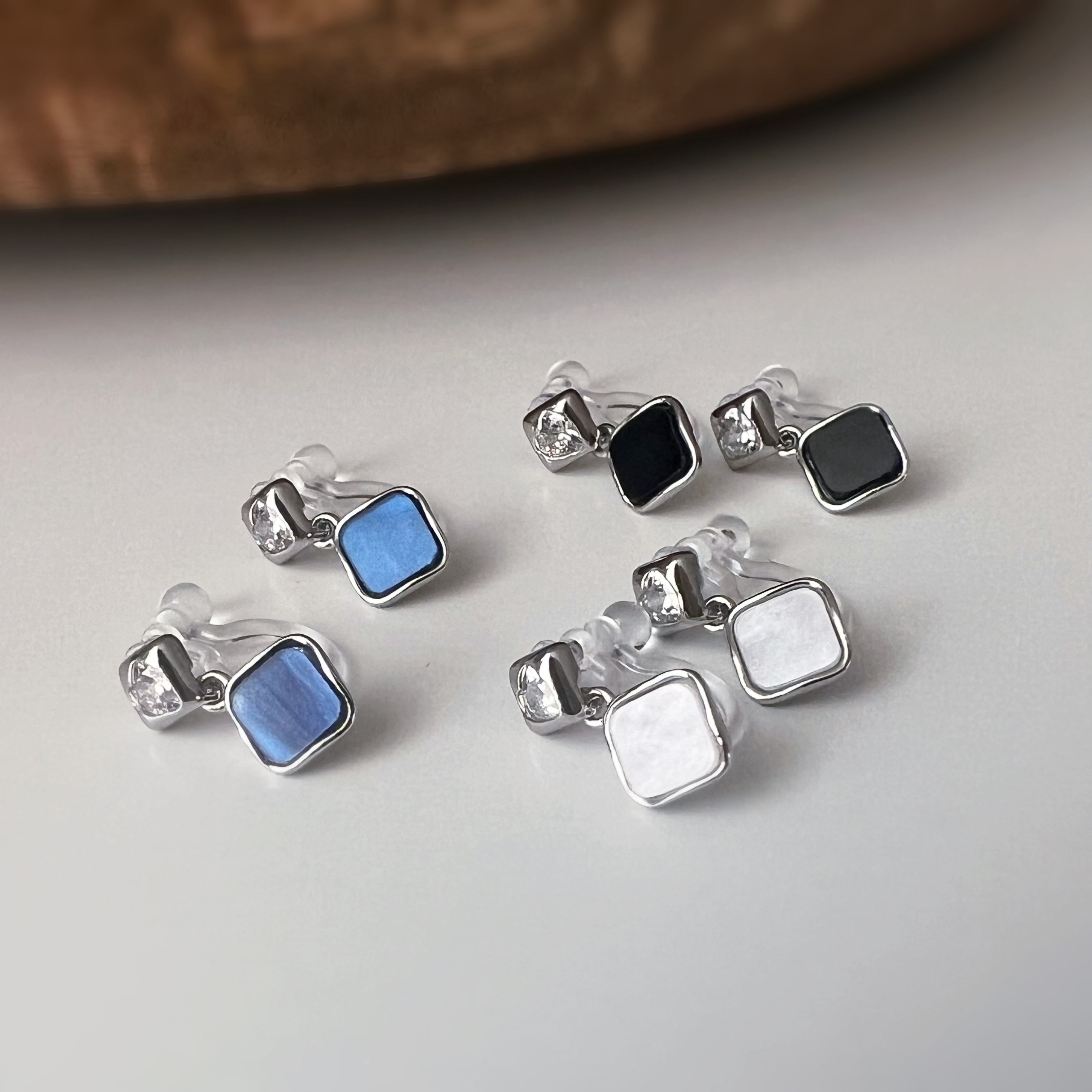 Square enameled clip-on earrings in silver, mother-of-pearl blue, black, or white