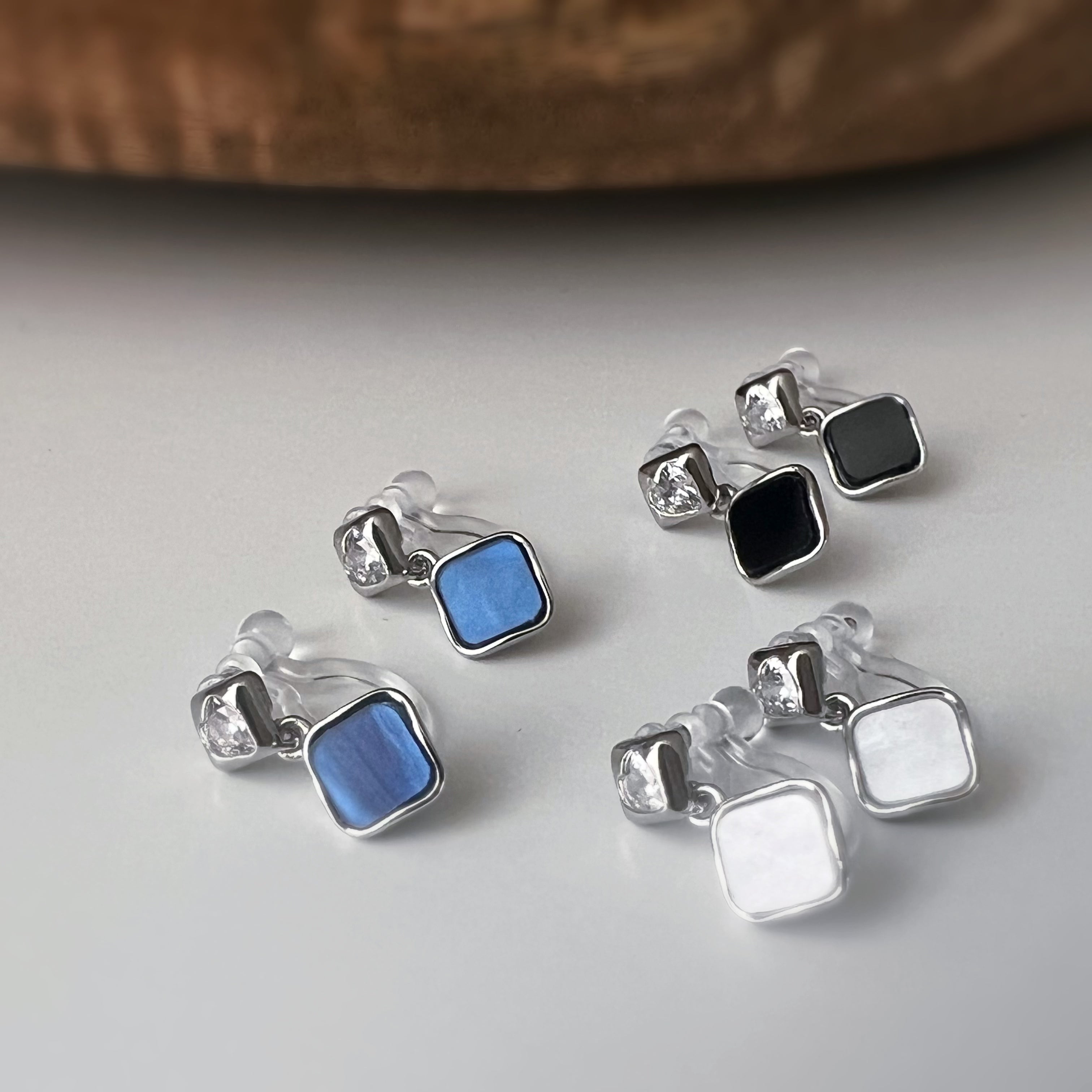 Square enameled clip-on earrings in silver, mother-of-pearl blue, black, or white