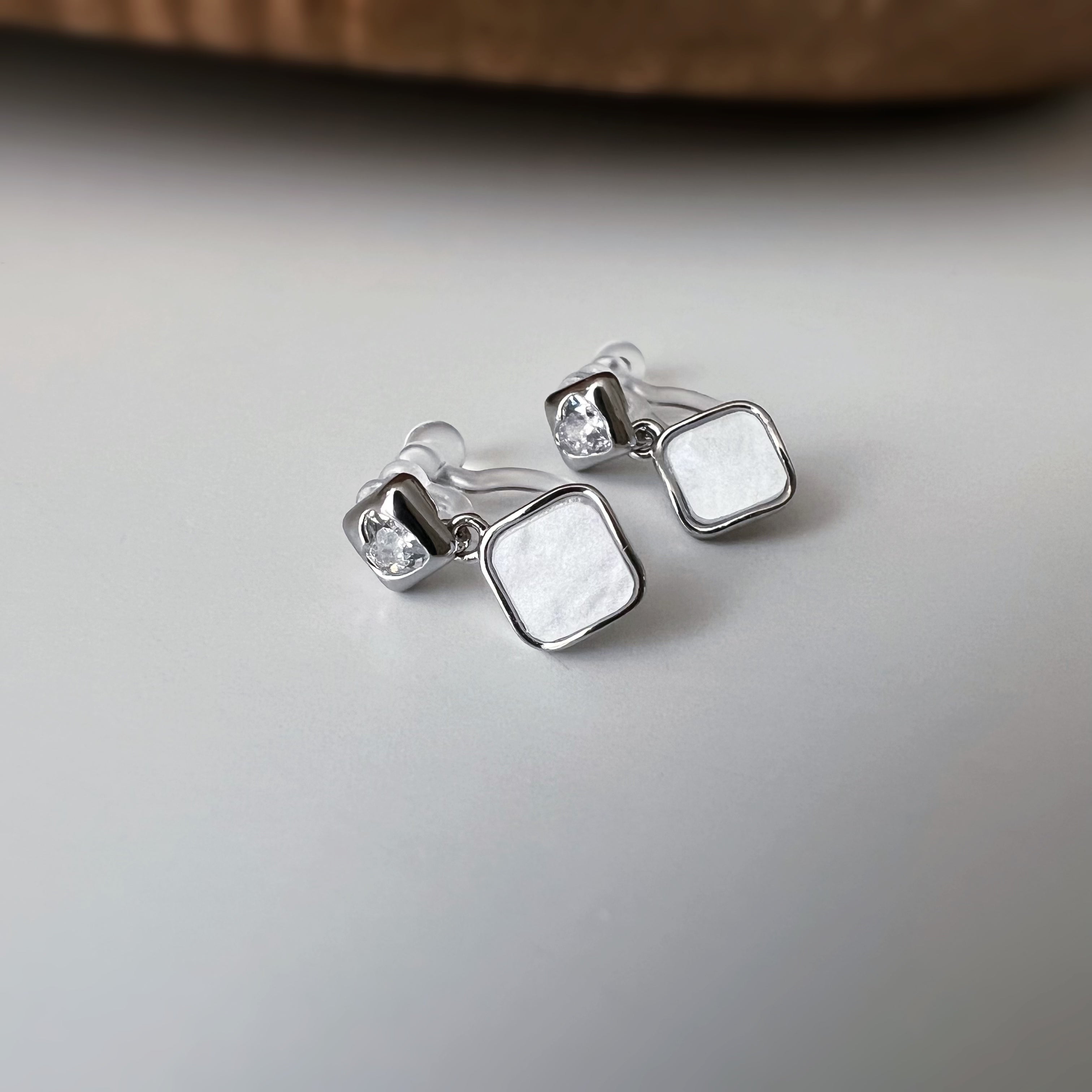 Square enameled clip-on earrings in silver, mother-of-pearl blue, black, or white