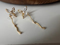 Clips d’oreilles papillon pendantes avec chaîne