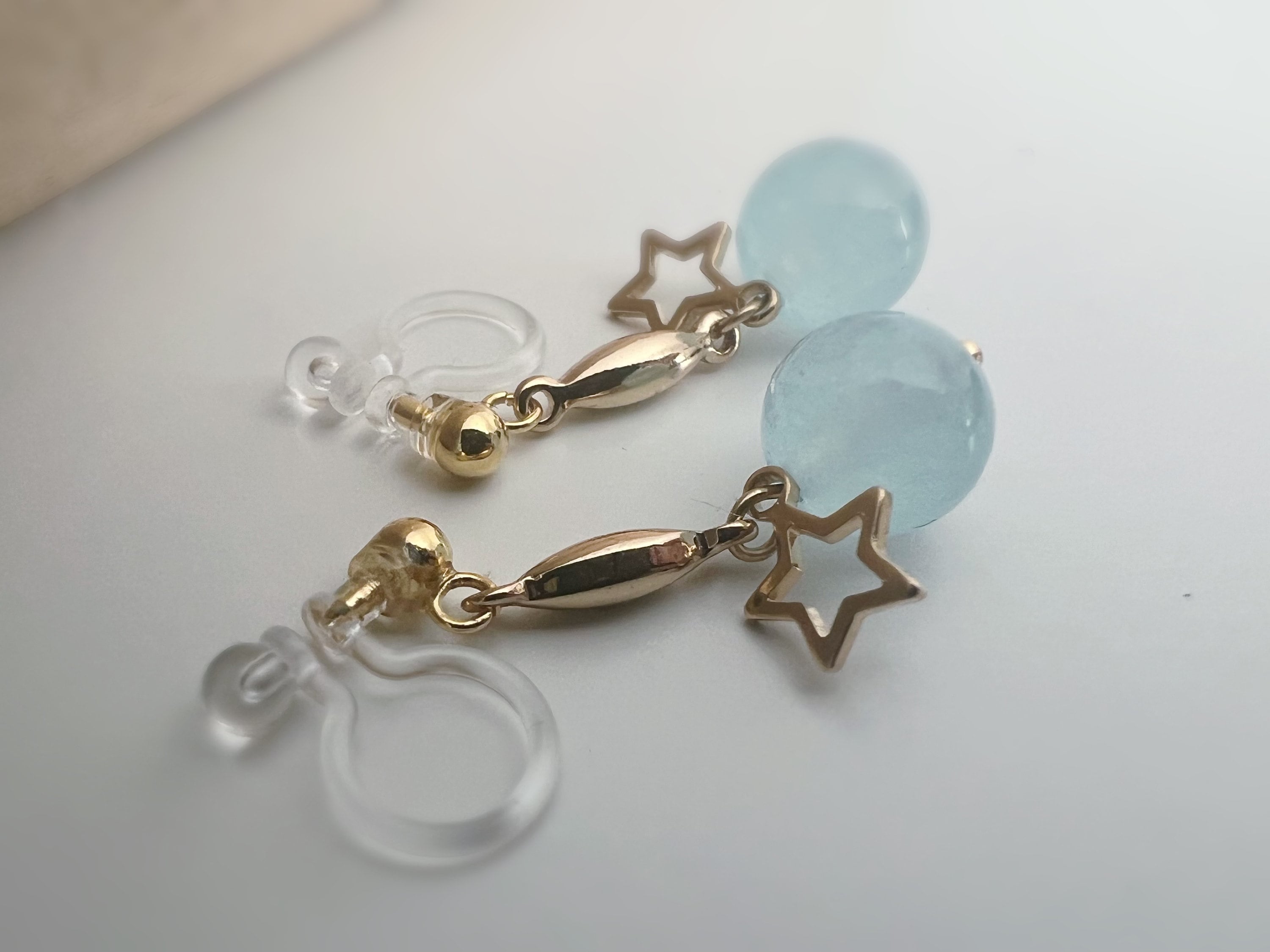 INVISIBLE CLIPS dangling earrings Gold, Pastel colored pearl macaroons Blue Pink Green Purple, Small hollow star.