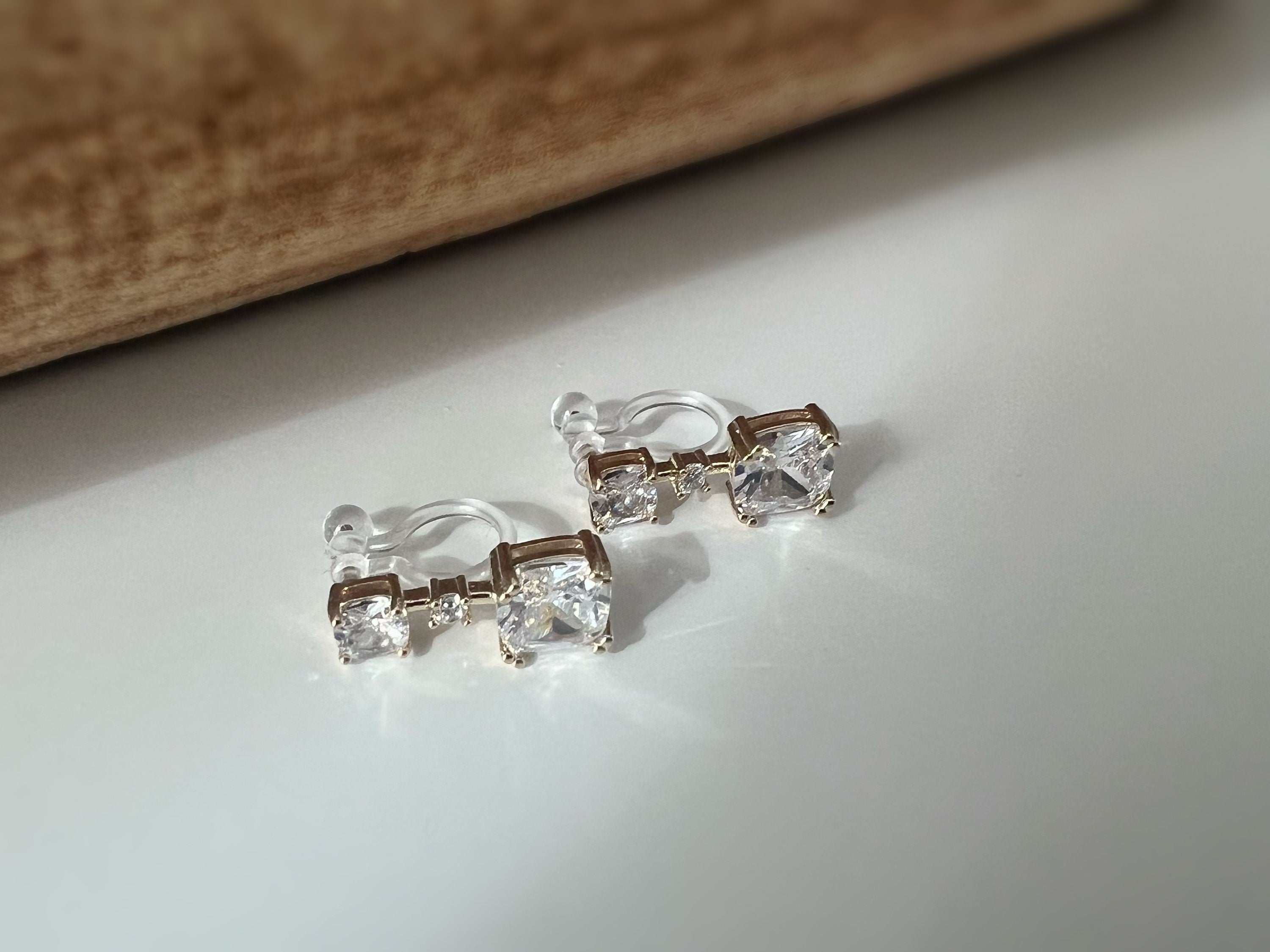 Clips d'oreilles invisibles Carré mini pierre zircon transparent. CLIPS confortable prêt à offrir