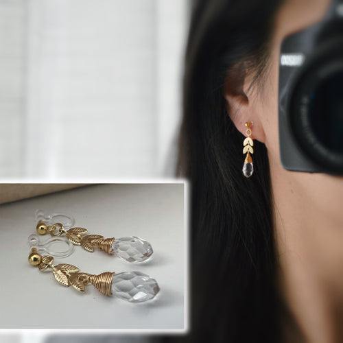 Gold leaf chain dangling ear clips with transparent faceted pearl in the shape of a drop of water Comfortable invisible clips.