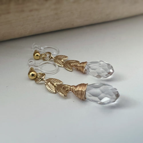 Gold leaf chain dangling ear clips with transparent faceted pearl in the shape of a drop of water Comfortable invisible clips.