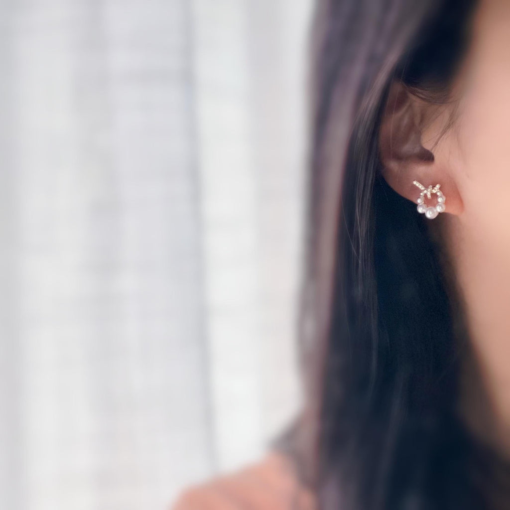 Boucles d’oreilles clip forme de couronne ornées perles blanches, strass scintillants. Finition dorée raffinée pour une touche sophistiquée.
