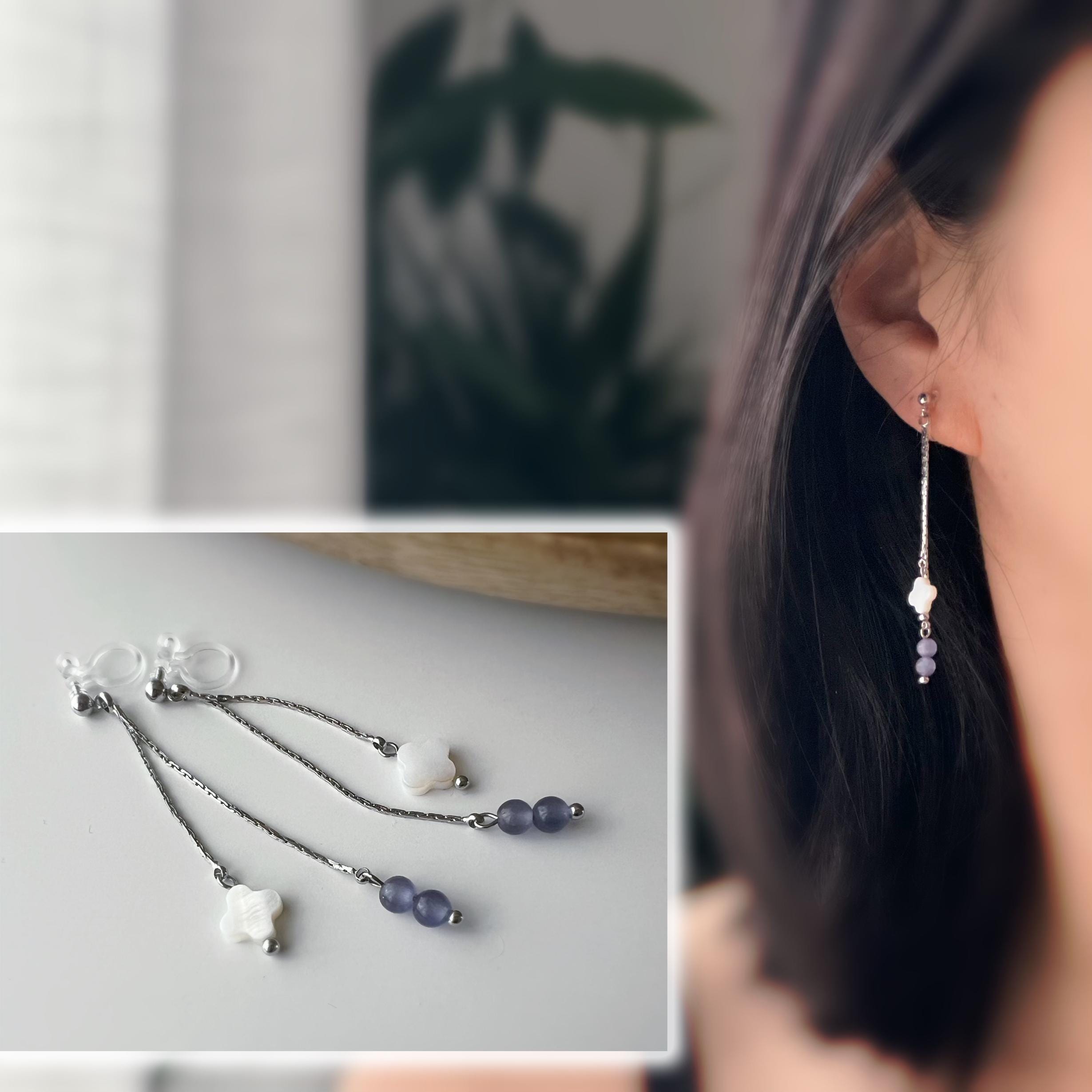Boucles d'oreilles clip élégantes Chaîne argentée Perles violettes Fleur blanche en nacre Légères raffinées parfait pour style délicat chic.