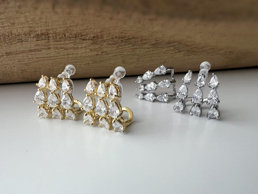 Boucles d'oreilles clips élégantes en zircon en forme de gouttes Or / Argent. Un design raffiné pour une touche de glamour et d'éclat.