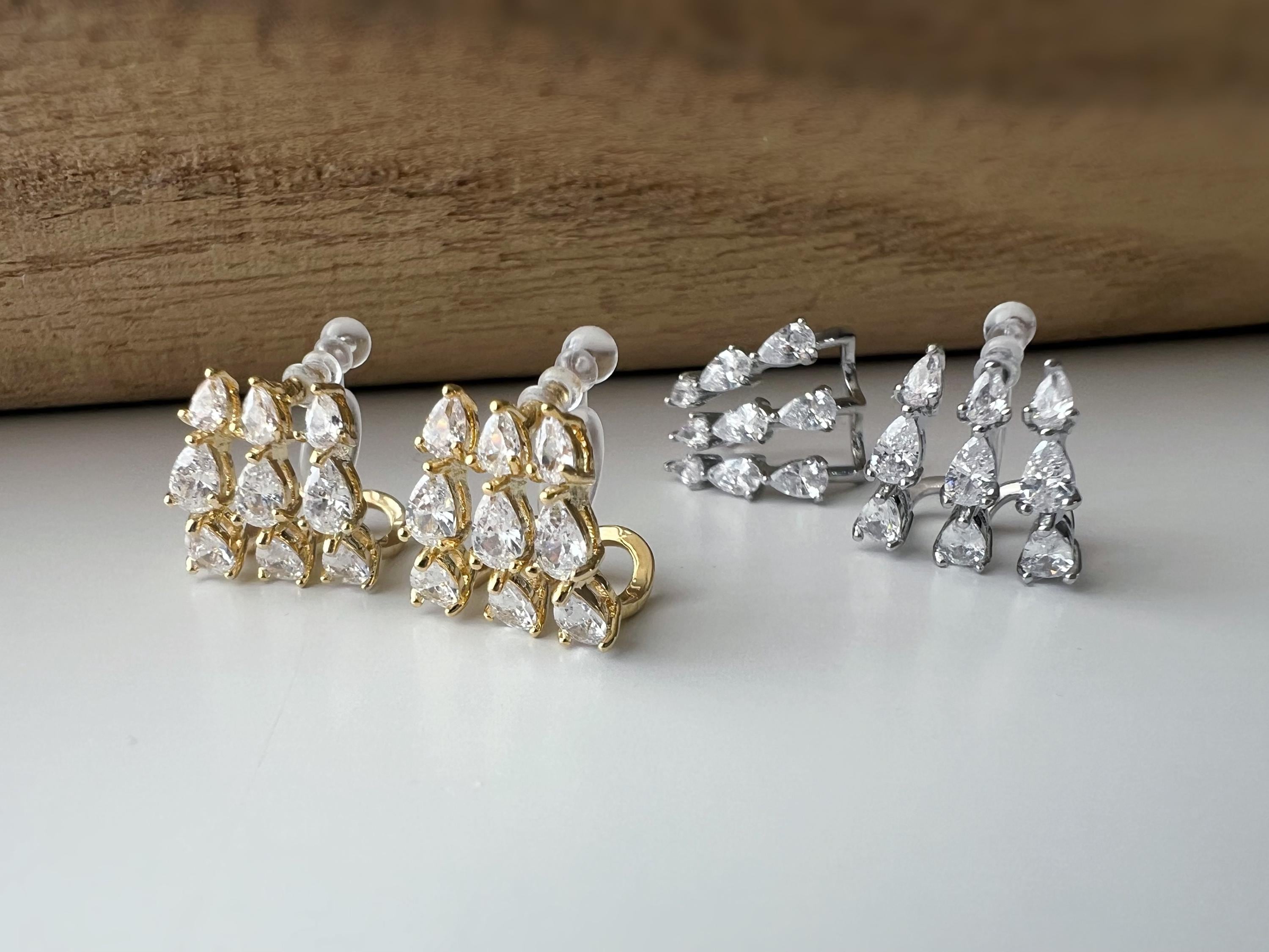 Boucles d'oreilles clips élégantes en zircon en forme de gouttes Or / Argent. Un design raffiné pour une touche de glamour et d'éclat.