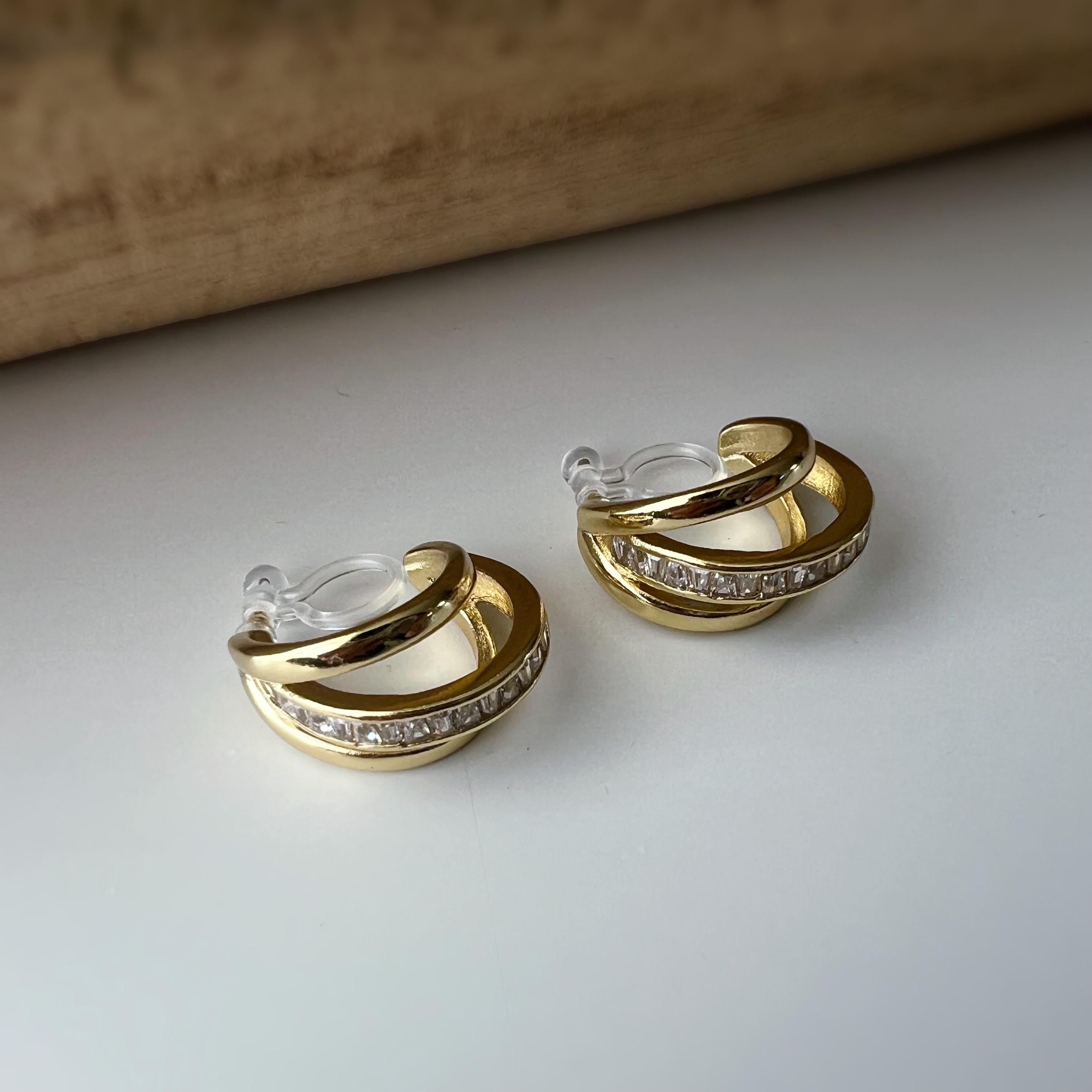 Boucles d'oreilles clip dorée triple anneau ornées strass scintillants Élégantes raffinées elles apportent une touche lumineuse sophistiquée