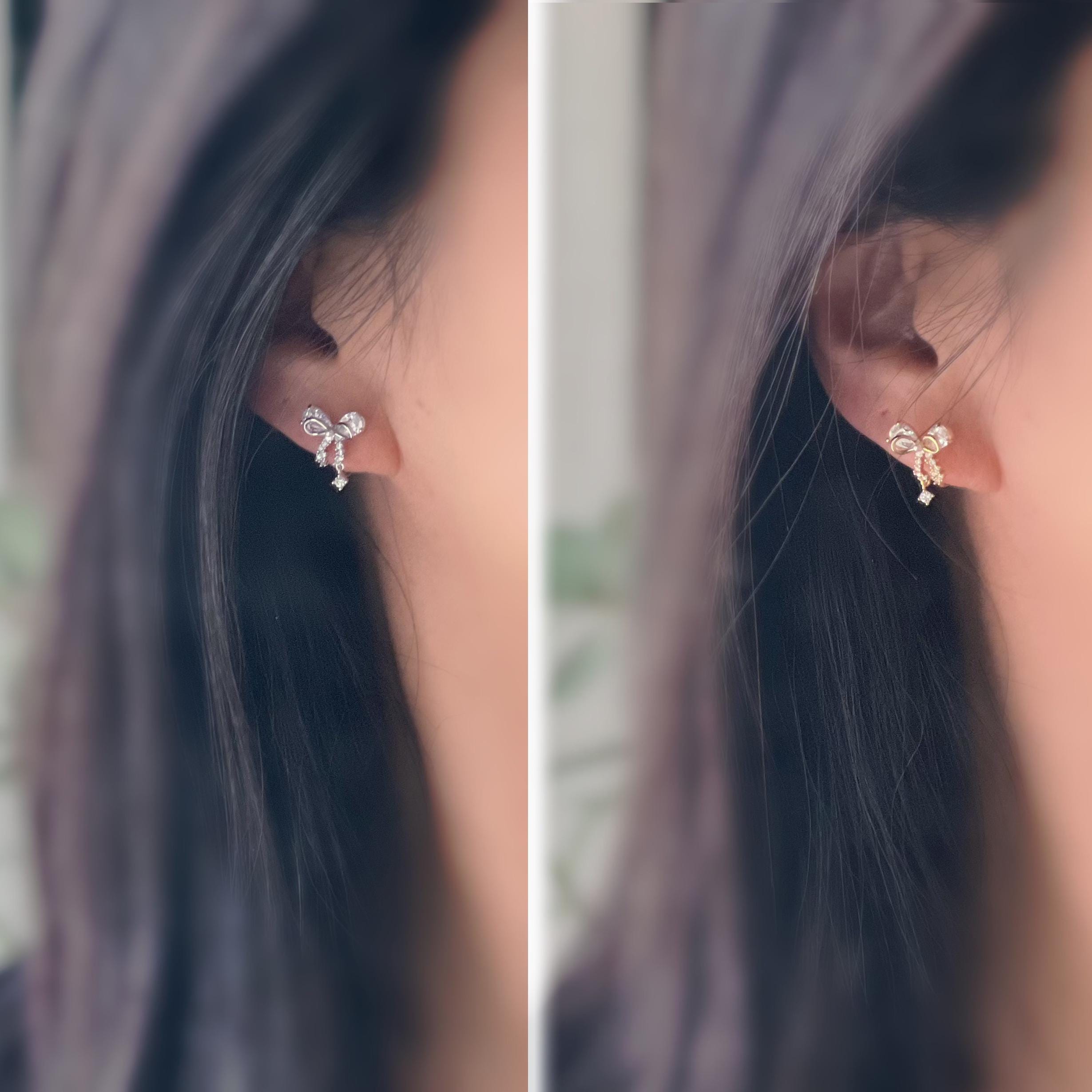 Clips d’oreilles papillon en strass, disponibles en doré et argenté. Design raffiné pour un look délicat, sans perçage.
